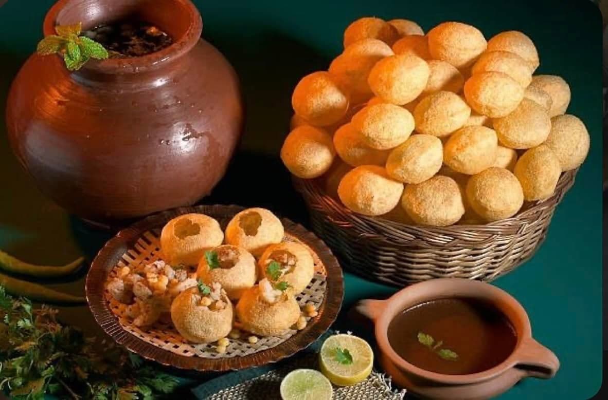 Pani puri — crispy puris filled with spiced potato and chickpeas, served with tangy mint water