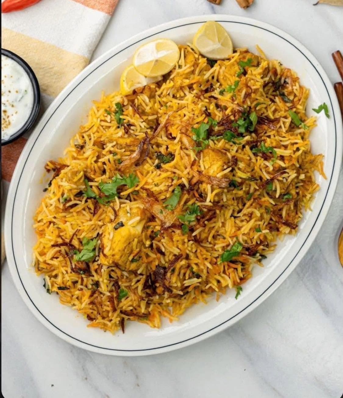 Chicken biryani, layered with saffron rice and fried onions